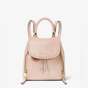 Michael Kors Viv Extra-Small Pebbled Leather Backpack in a light pink color